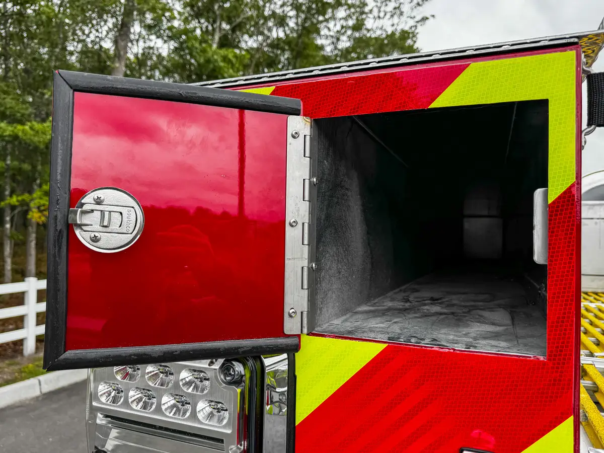 Rear corner close-up with taillight stack, side marker, and chevron wrap.